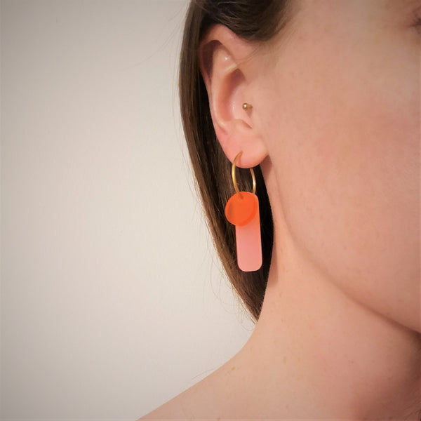 Gold hoop earrings with pink and orange acrylic model