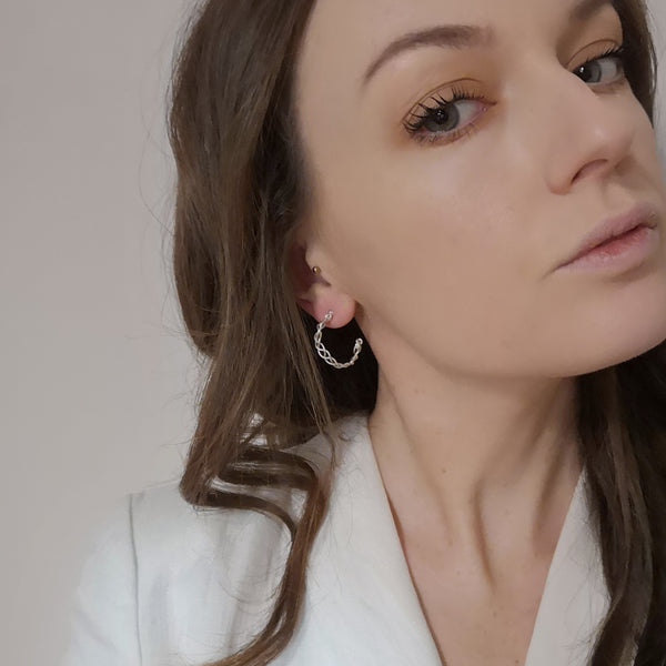 Solid silver plait hoop earrings model