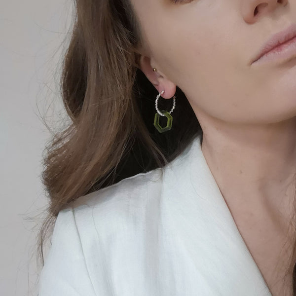Solid silver wrap and green hex acrylic hoop earrings model