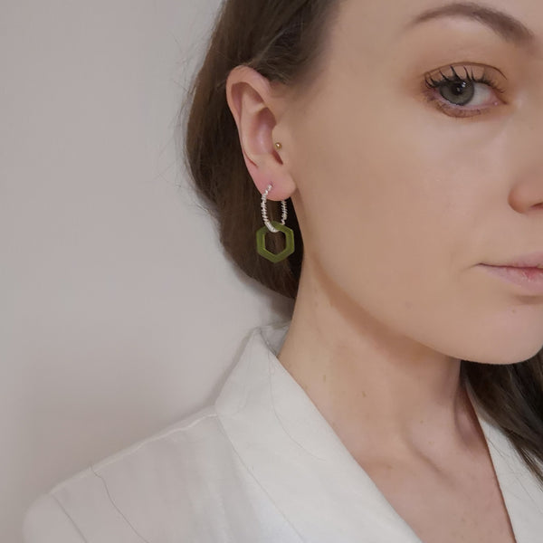 Solid silver wrap and green hex acrylic hoop earrings model